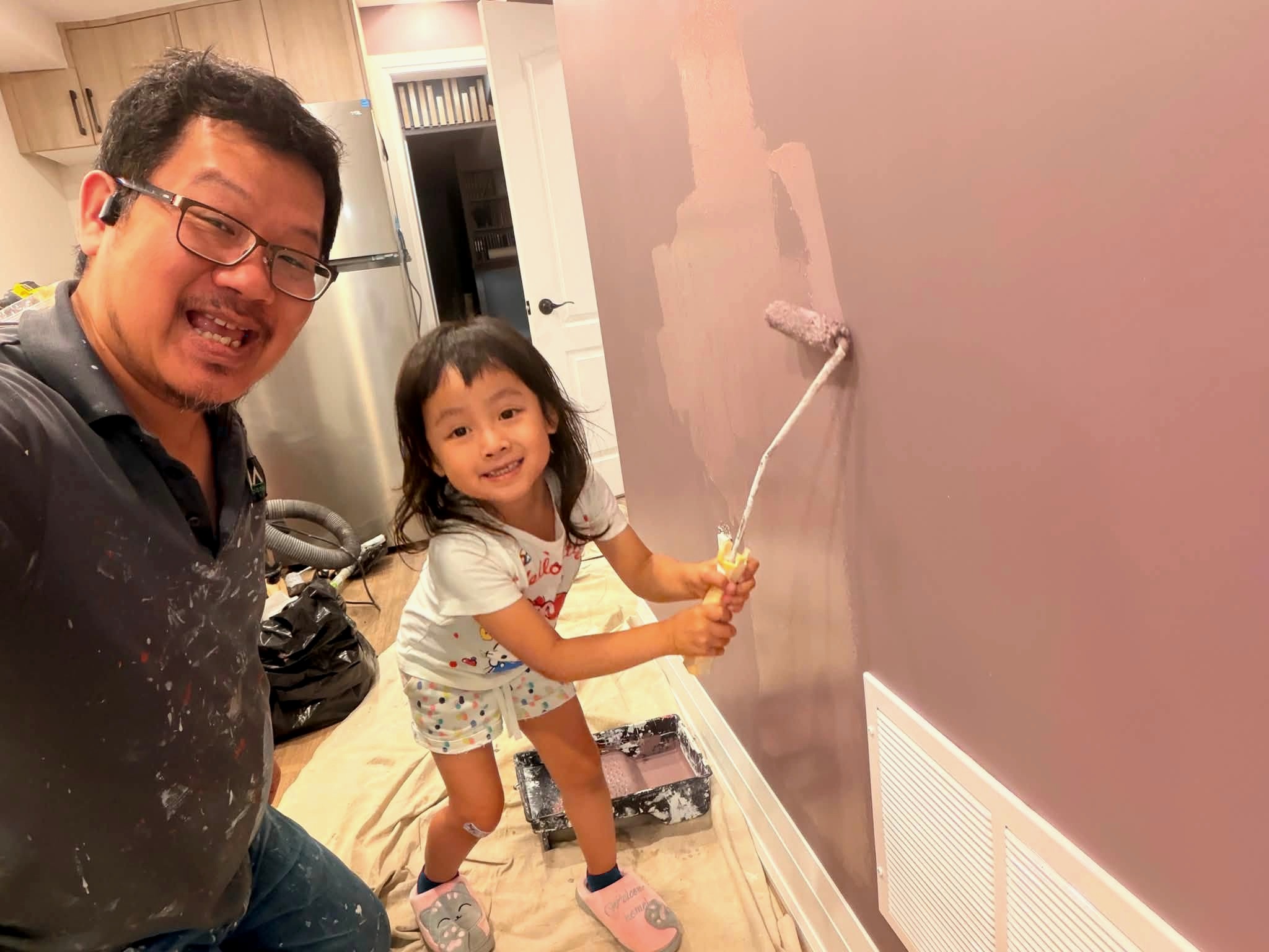 Yan, founder of JR Renocraft, painting a wall together with his daughter Abby