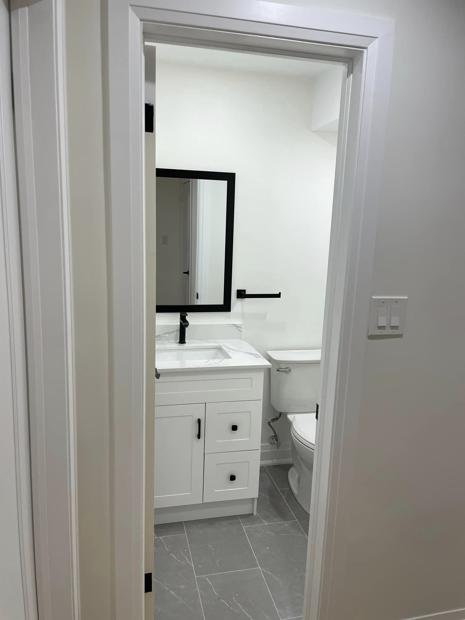 North York basement bathroom two after renovation with updated vanity and fixtures