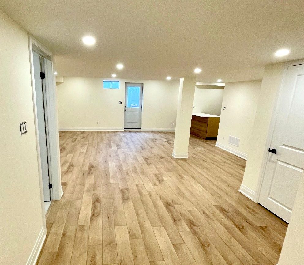 Richmond Hill basement open living area with vinyl plank flooring