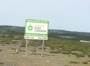 A roadside billboard reading "Stay Canada" that Yan saw during his cross-country bicycle trip